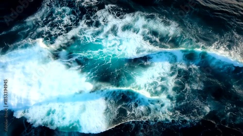 Aerial view of ocean waves crashing and foaming in the sea.