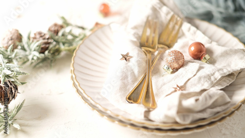 Elegant Christmas Table Setting with Gold Cutlery and Festive Ornaments