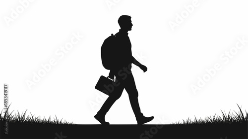 Silhouette of a businessman walking with briefcase.