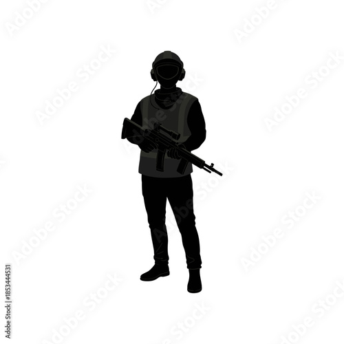 Soldier in tactical gear holding assault rifle in dark environment