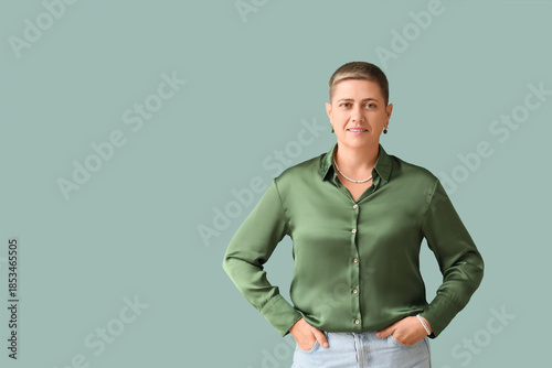 Young woman with short hair in blouse on green background