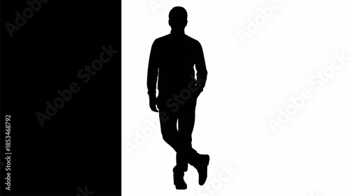 Silhouette of a man standing confidently with crossed legs.