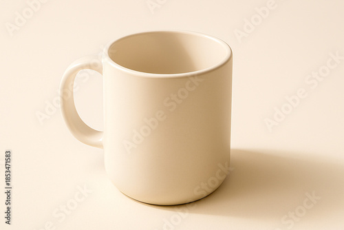 White ceramic mug on matte white table with soft warm daylight reflection.