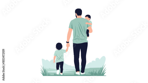 A father walks with his two young children, one held in his arms and the other holding his hand, in a grassy outdoor setting.
