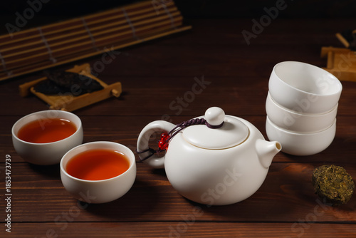 Teapot and cups with brewed...