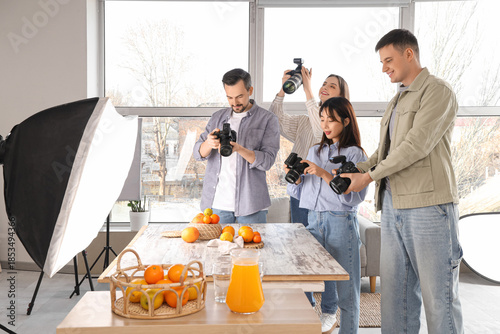 Photographers taking pictures of fruits during master class in studio