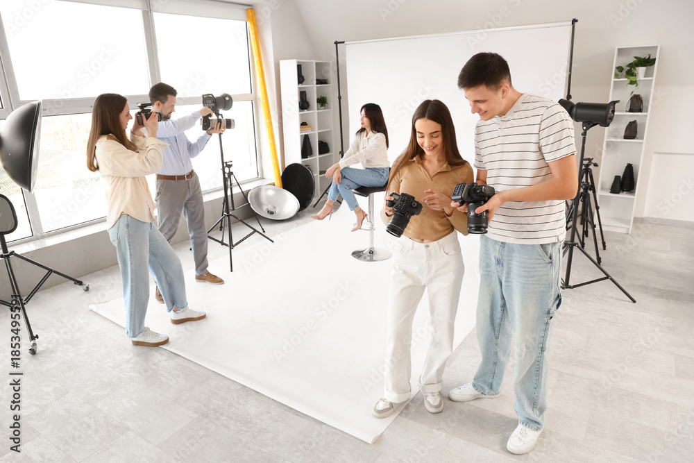 Fototapeta premium Photographers with cameras during master class in studio