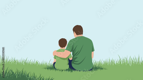 A father and son sitting on the grass, with the father's arm around the son's shoulders, looking out at the horizon.