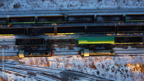 Aerial View of Cargo Trains and Locomotives on Snowy Railway Tracks