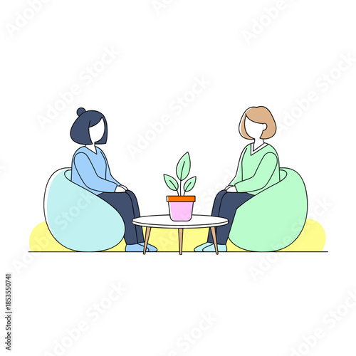 Women sitting on bean bags while talking around a coffee table  