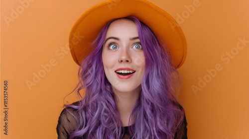 Surprised woman with purple hair wearing orange hat