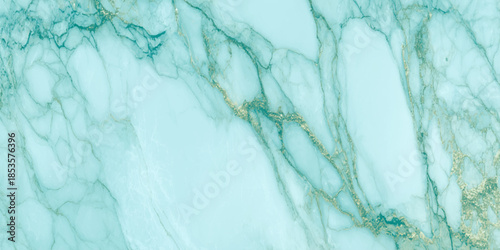 A striking close up view of polished turquoise marble with delicate golden veins running throughout the surface texture