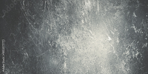 A grayscale image displaying a heavily textured surface with scratches marks and subtle light variations