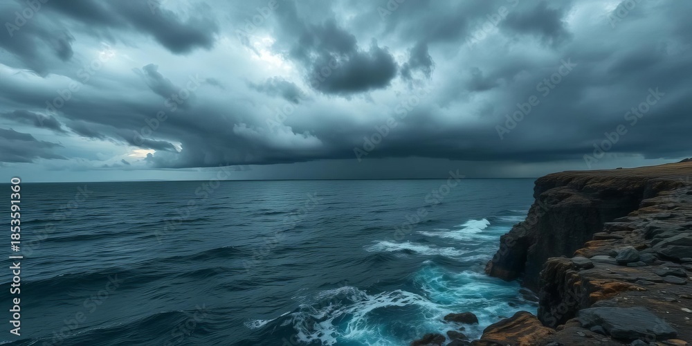 Obraz premium Dark stormy sea with ominous clouds, rocky cliff edge, ocean, waves