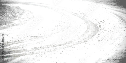 Tire tracks curving on a bright, high-contrast dirt road in black and white