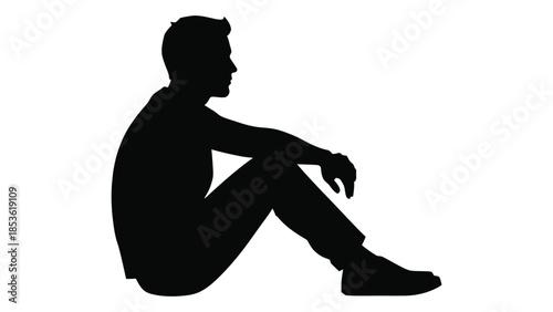 A solitary man sitting in a relaxed pose a stark black form silhouette