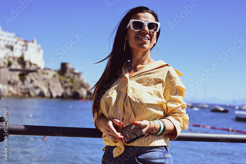  Happy smiling beautiful  Tourist woman   traveling in Italy poses and making photos  Vacation on  Positano and Amalfi coast in Italy.  Italy trip 