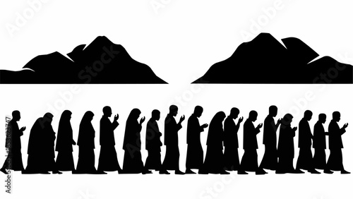 Silhouette of people walking in a line with mountains.