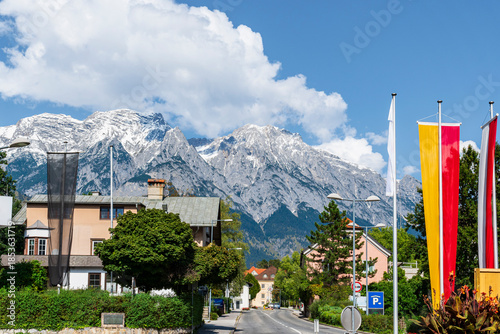 Alpine Town Street With Snow Capped Mountains and Blue Sky