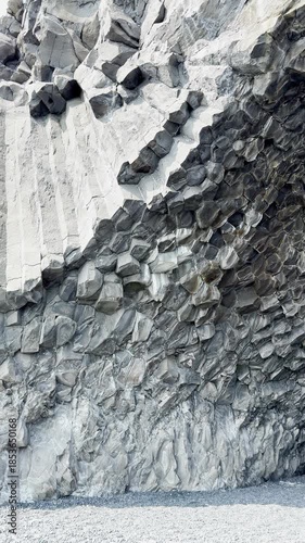 Outdoors, Iceland landscape, view of a basalt cliffs on the coast of Iceland, vertical view, earth texture and dark sand, shore nature background.
