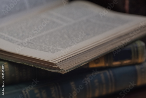 Photography Old leather bound  book open with defocussed words for use as a background