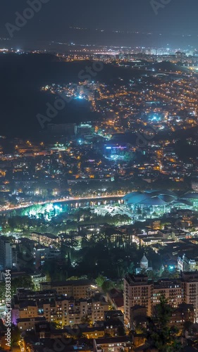 Wallpaper Mural Illuminated Tsminda Sameba Cathedral or Holy Trinity Cathedral of Tbilisi and Public Service Hall aerial night timelapse. The main cathedral in Tbilisi, Georgia. Houses on background Torontodigital.ca