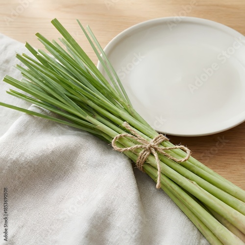 Fresh lemongrass stalks tied with twine on a white cloth
