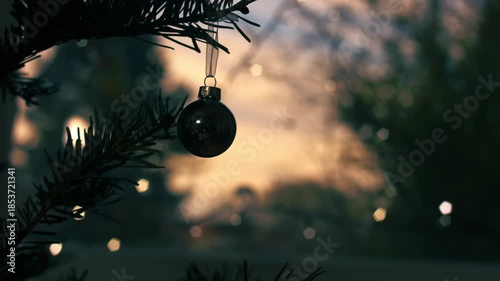 Christmas babule on tree with twinkling lights background