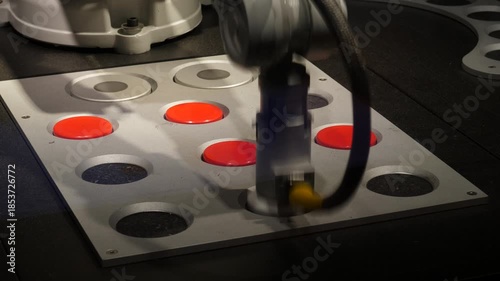 Robot remove round plates from Tic-tac-toe board after game was over. Industrial manipulator arm touch disc, lift it up and move away