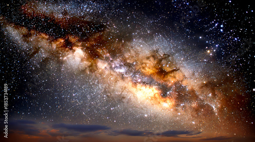 Stars and colors fill the night sky. Bright stars shine in the night sky above a dark landscape. Colors swirl among the stars, creating a vast scene.