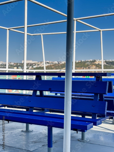 Close up of blue wooden bench seat on a ferry deck