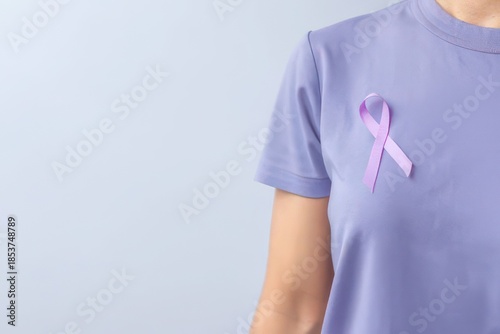 Person wearing lavender t-shirt with pink awareness ribbon for support and solidarity