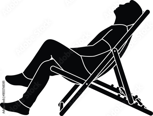 A silhouette of a person relaxing on a folding beach chair outdoors
