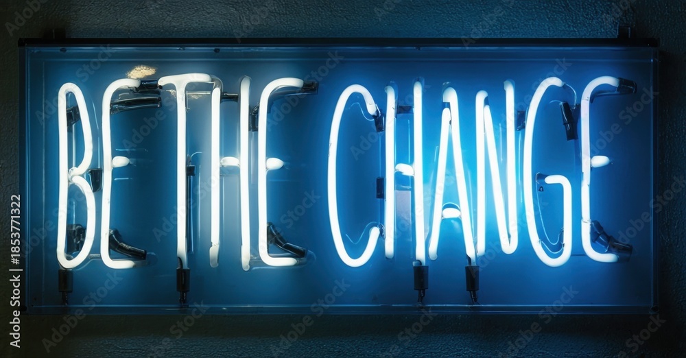 Fototapeta premium Bright neon sign displays inspirational message. Blue light illuminates dark wall, creating dramatic effect. Simple, bold typography.