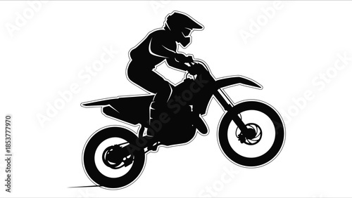 Silhouette of a motocross rider skillfully maneuvering a dirt bike in action