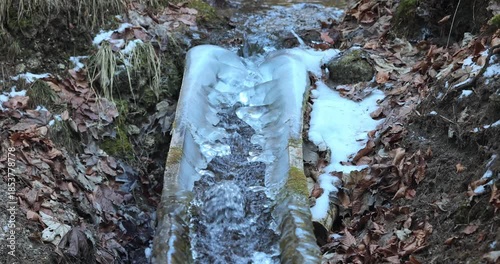 Wallpaper Mural Winter's embrace: a channel of water adorned with shimmering ice formations, a testament to nature's artistry during the colder months. A contrast between flow and freeze. Torontodigital.ca