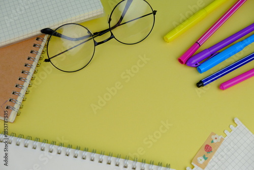 Open blank spiral notebook with black pencil on yellow background. Empty Space for your text. business and education concept