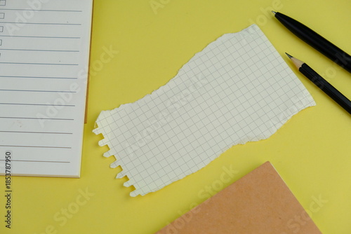 Open blank spiral notebook with black pencil on yellow background. Empty Space for your text. business and education concept