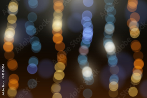 Abstract colorful bokeh lights background with glowing particles.