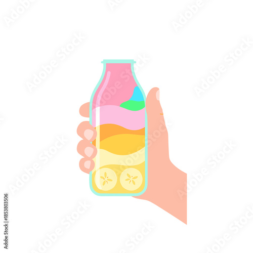 Hand holding a colorful fruit smoothie in a glass bottle  