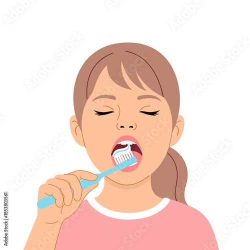 Young girl brushing her teeth with a toothbrush in close-up  