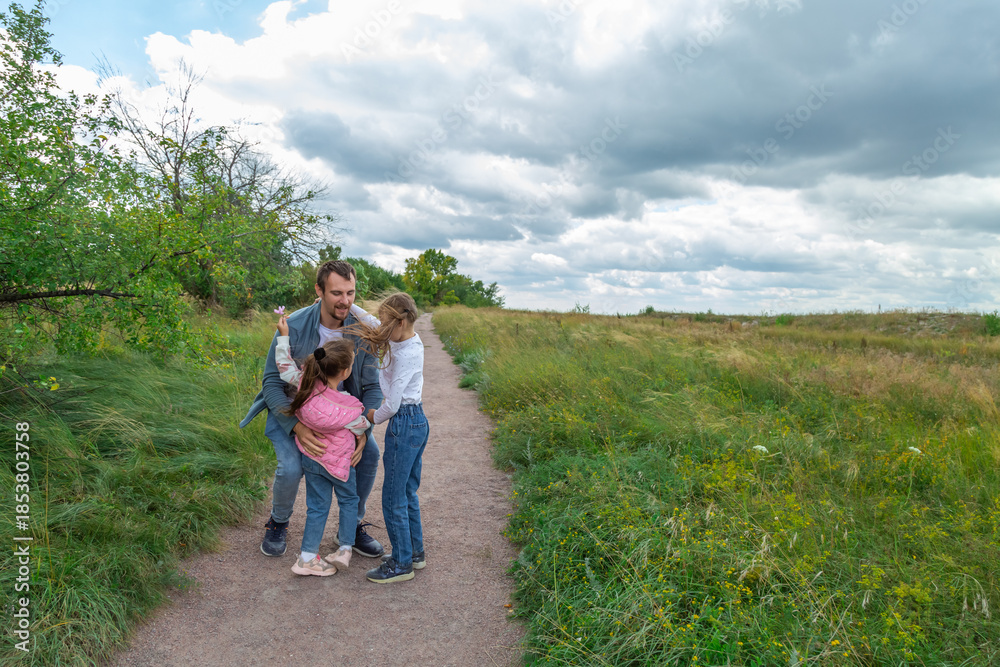 Fototapeta premium Father and children have fun, laugh and enjoy nature outdoors.