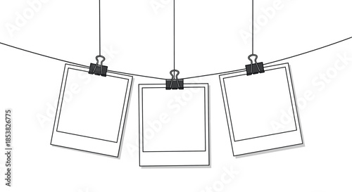 Three blank instant photo frames hanging from a horizontal wire with black binder clips against a white background.