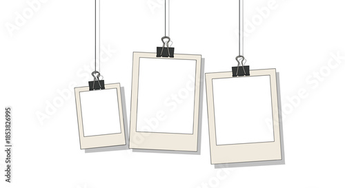 Set of blank polaroid style photo frames hanging on strings with black clips against a plain white background for collage.