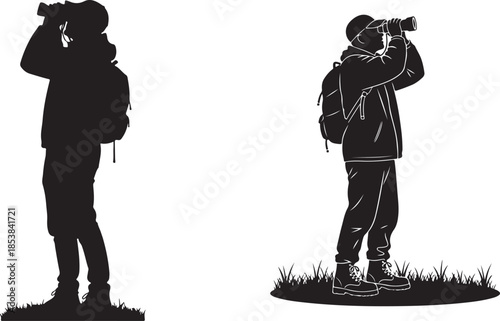 Black silhouette of hiker with backpack and binoculars standing on grass