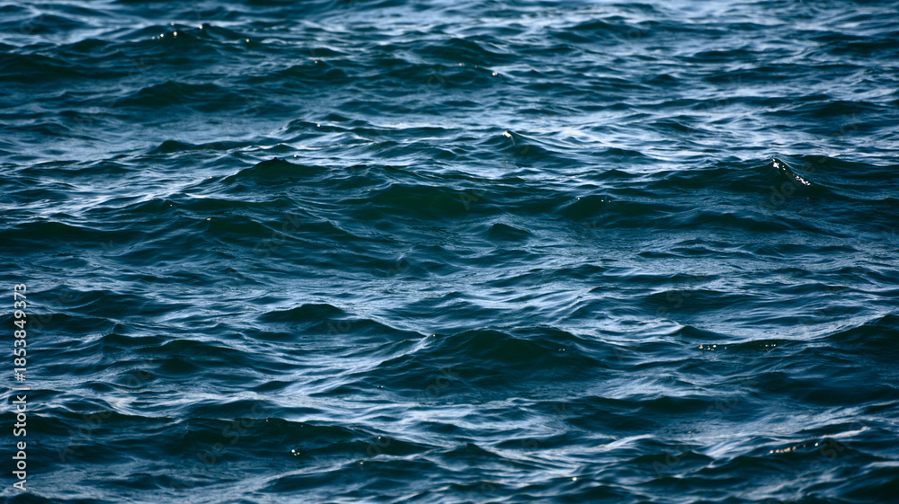 Obraz premium Calm blue sea surface with gentle ripples.