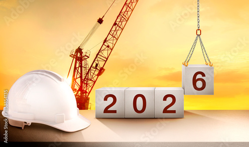 A construction crane is lifting and placing the number 6 in a cube to celebrate the start of the new year 2026 in the construction industry.