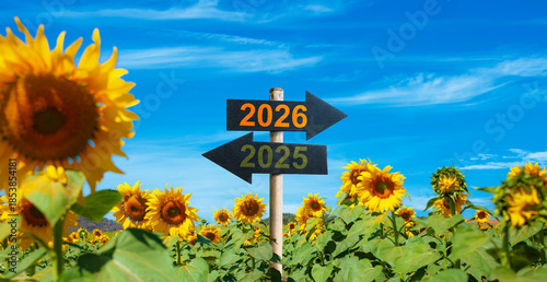 2026 to the right and 2025 to the left. road signs in the sunflower garden. start to be Successful in the new year.