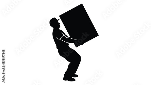 Silhouette of a worker wearing a cap struggling to lift a heavy rectangular object carefully