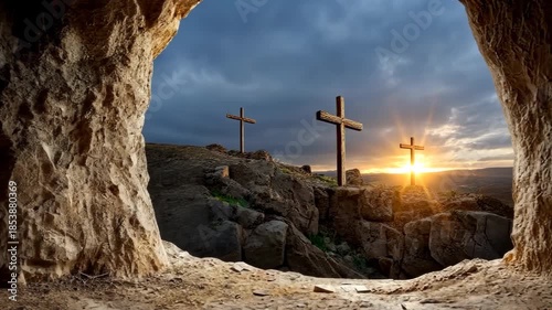 Looking out from inside empty tomb towards three crosses on Golgotha hill at sunrise during Easter